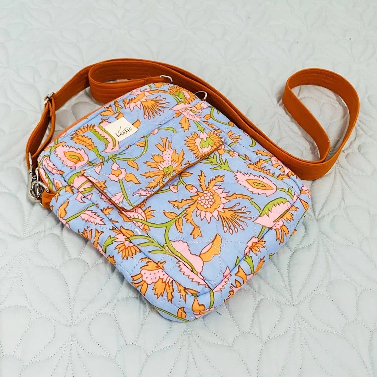 Freesia Sling: Vertical Quilted Sling Bag: Orange Flowers on Blue